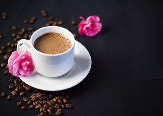 white espresso Cup and pink flowers on the table