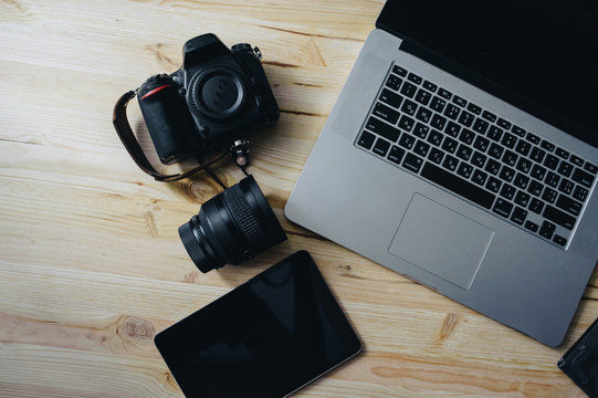 Photo journalism. Laptop, camera, tablet, note, camera lens.