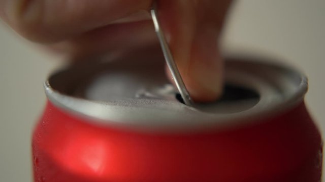 Pulling the soft drink can's pull tab