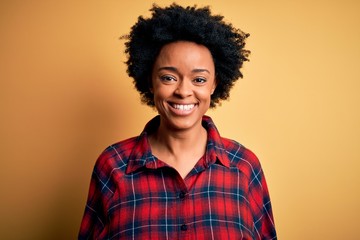 Obraz na płótnie Canvas Young beautiful African American afro woman with curly hair wearing casual shirt with a happy and cool smile on face. Lucky person.