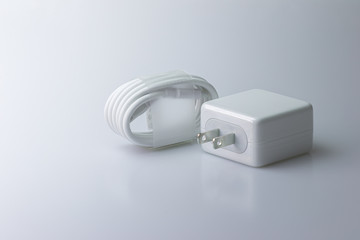 Mobile Phone Charger and USB Type-C Cable for the smartphone on a gray background.