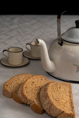 A table arrangement with, teapot, breads and cookies