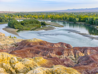 Obraz na płótnie Canvas Colorful Rainbow Beach, or Wucaitan, Located along the Irtysh (Ertix) River in northern Xinjiang, a Yardang landscape carved from river bedrock by the dual action of wind abrasion by dust and sand