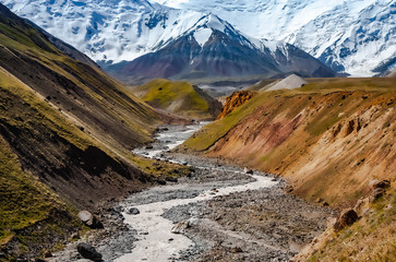 Beautiful landscape. Hilly area. The sandy gorge. Mountainious terrain.  Snowy peaks.