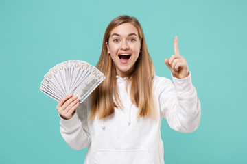 Excited young woman girl in casual white hoodie isolated on blue turquoise background. People...