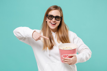 Funny young woman in casual white hoodie 3d glasses isolated on blue turquoise background. People...