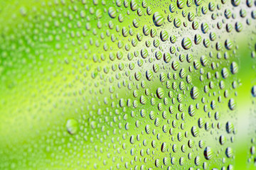 Drops of water for the background on window glass with green background