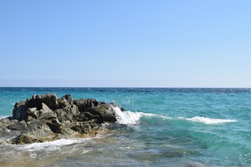Fototapeta na wymiar Geremeas, sardinia, Italy, Kal'e Moru beach waves crashing in the rock with sea background