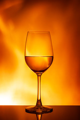 Glass of white wine on an orange background