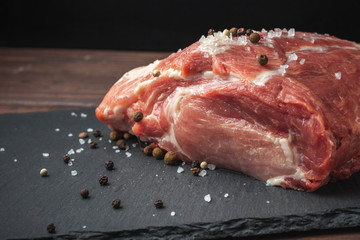 Raw pork chop steak on a black board. Pork antricot