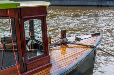 Fototapeta na wymiar A vintage sightseeing tourist boat is tied the the jetty on the Yarra River at Southbank, Melbourne, Australia