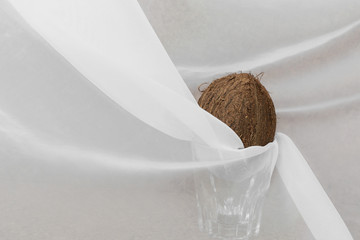 The view of coconut is on the glass among the windy tulle. Coconut vegan milk lactose free. Copy...
