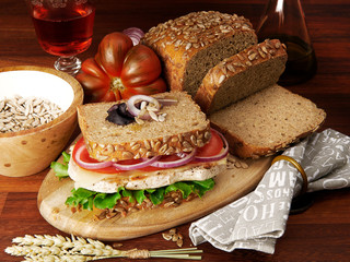 homemade chicken and vegetables wholemeal bread sandwich with ingredients in wood table background