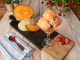 homemade melon ice cream cup with wood table background
