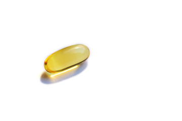 Yellow vitamin d capsule on a white background