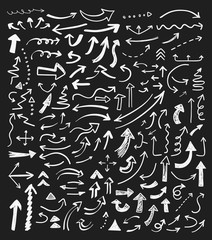 Hand drawn doodle arrows set on a blackboard background