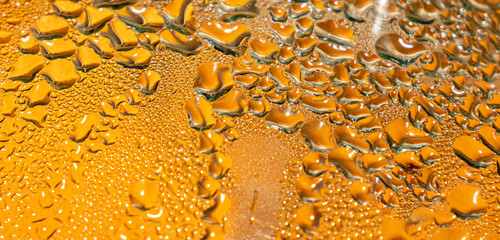 Crystal clear water drops over red background