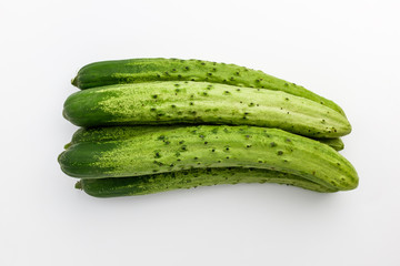 Elongated raw cucumber with background