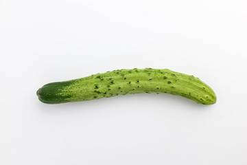 Elongated raw cucumber with background