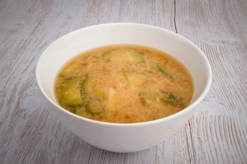 Miso soup with vegetables in the background