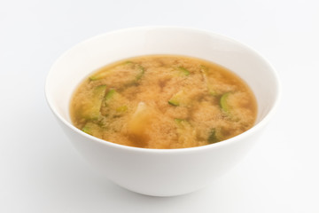 Miso soup with vegetables in the background