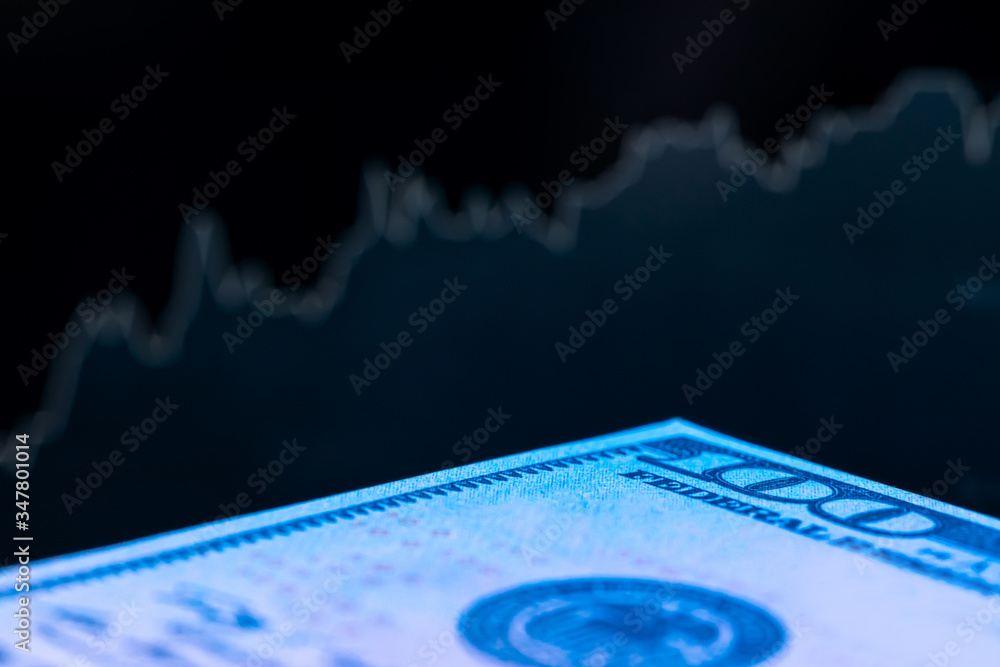 Poster dollars in front of a monitor with a price chart. forex and trading. close up.