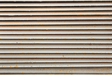 Obraz premium abstract background of an old ventilation grill in spots of rust close up
