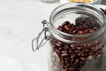 Raw cereals or beans in glass jars close up. Vegan and vegetarian food. Close up.
