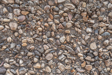 abstract background concrete surface decorated with small pebbles close up