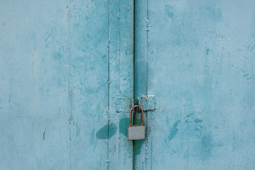 abstract background of old metal doors with a padlock close up