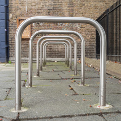 Row of empty Sheffield stand bike racks on the pavement