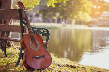 View of Acoustic guitar at lake. background the nature of the lake.