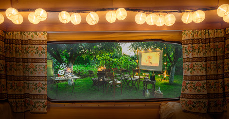 Summer cinema in the evening, view from camper window