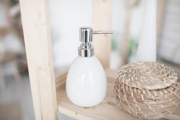 White soap dispenser in a stylish interior.
