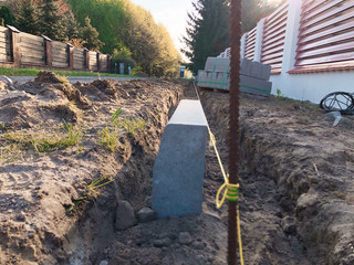 road repair in the village among the houses of inserting curb , dug a ditch from the ground,...