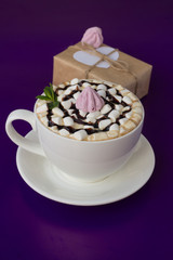 Mug of hot chocolate with marshmallows on a blue background