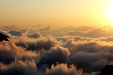 above the clouds, sunset in the mountains
