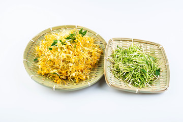 Bamboo sieve filled with fresh wild honeysuckle on white background