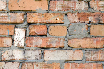 Wall surface with red brick and cement. Curve and sloppy masonry.