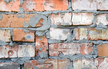 Wall surface with red brick and cement. Curve and sloppy masonry.