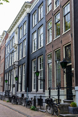 Fototapeta na wymiar Old traditional leaning houses in Amsterdam, Netherlands