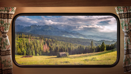 Green valley at sunset in Tatras, view from camper window