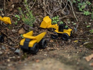 Toy construction machinery working on an excavation