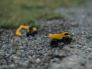 Toy construction machinery working on an excavation