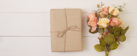 Beautiful flower and gift box on wooden background with romantic, presents for mother day or valentine day with pastel tone, nature for decoration on desk, holiday concept, banner website.