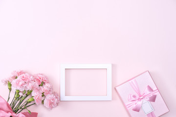 Mother's Day, Valentine's Day background design concept, beautiful pink carnation flower bouquet on pastel pink table, top view, flat lay, copy space.