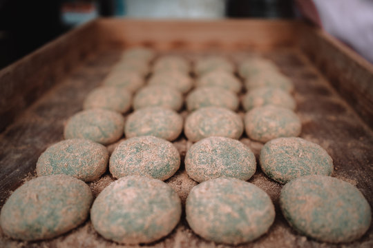 A Line Of Mochi Topping With Red Sugar In A Wood Box With Selective Focus