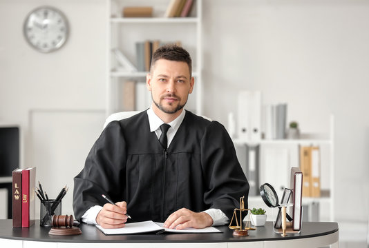 Male judge working at table in office
