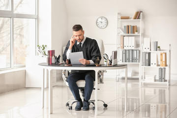 Male judge working at table in office