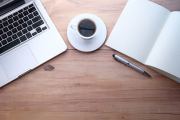 Top view of laptop, notepad, tea with copy space.